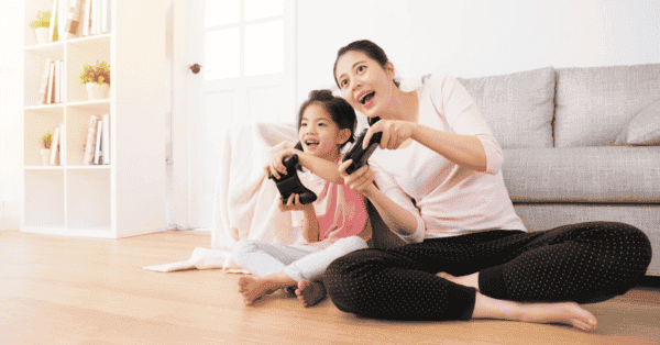 Daughter and mom playing video game